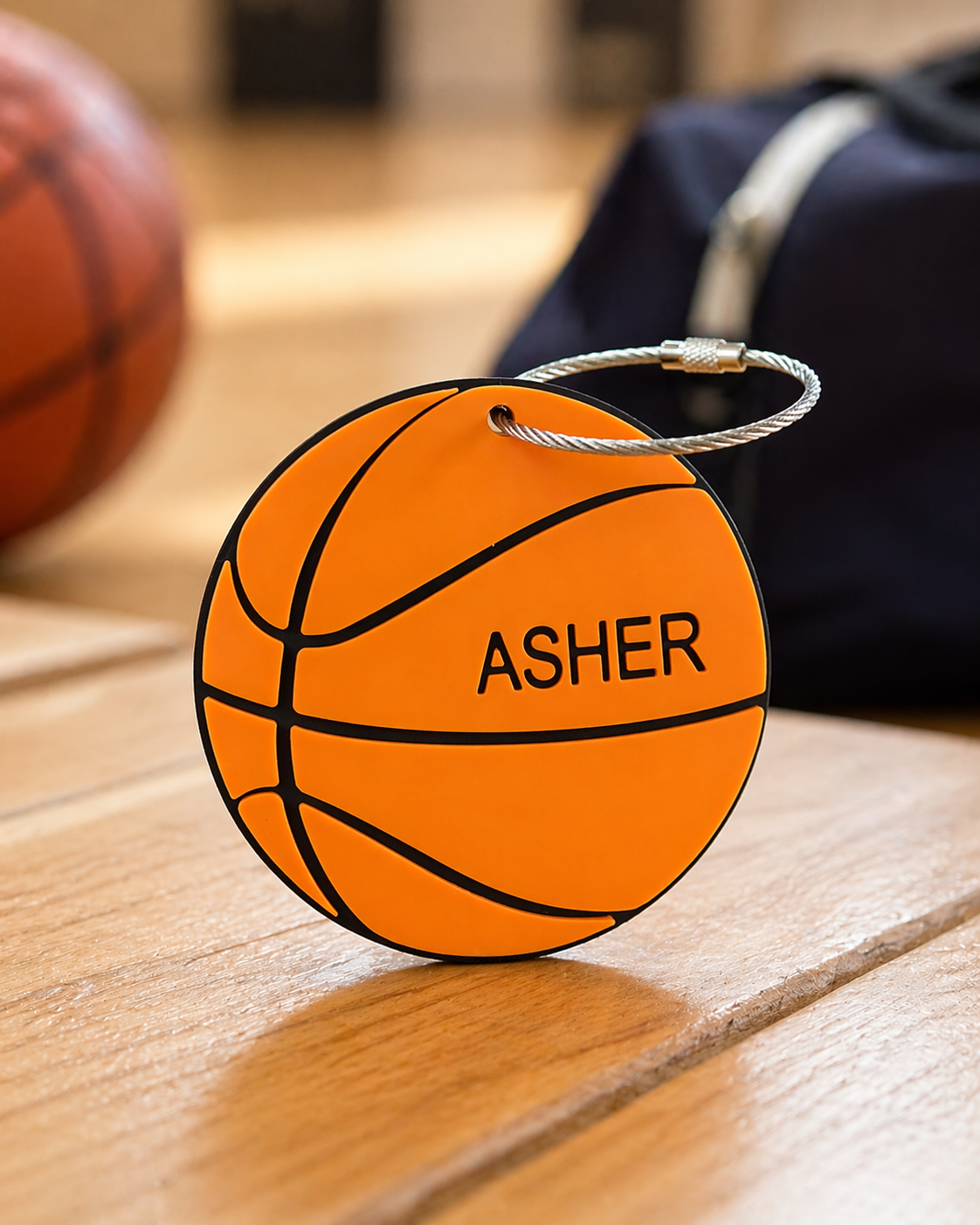 Personalized basketball bag tag displayed on a wood surface