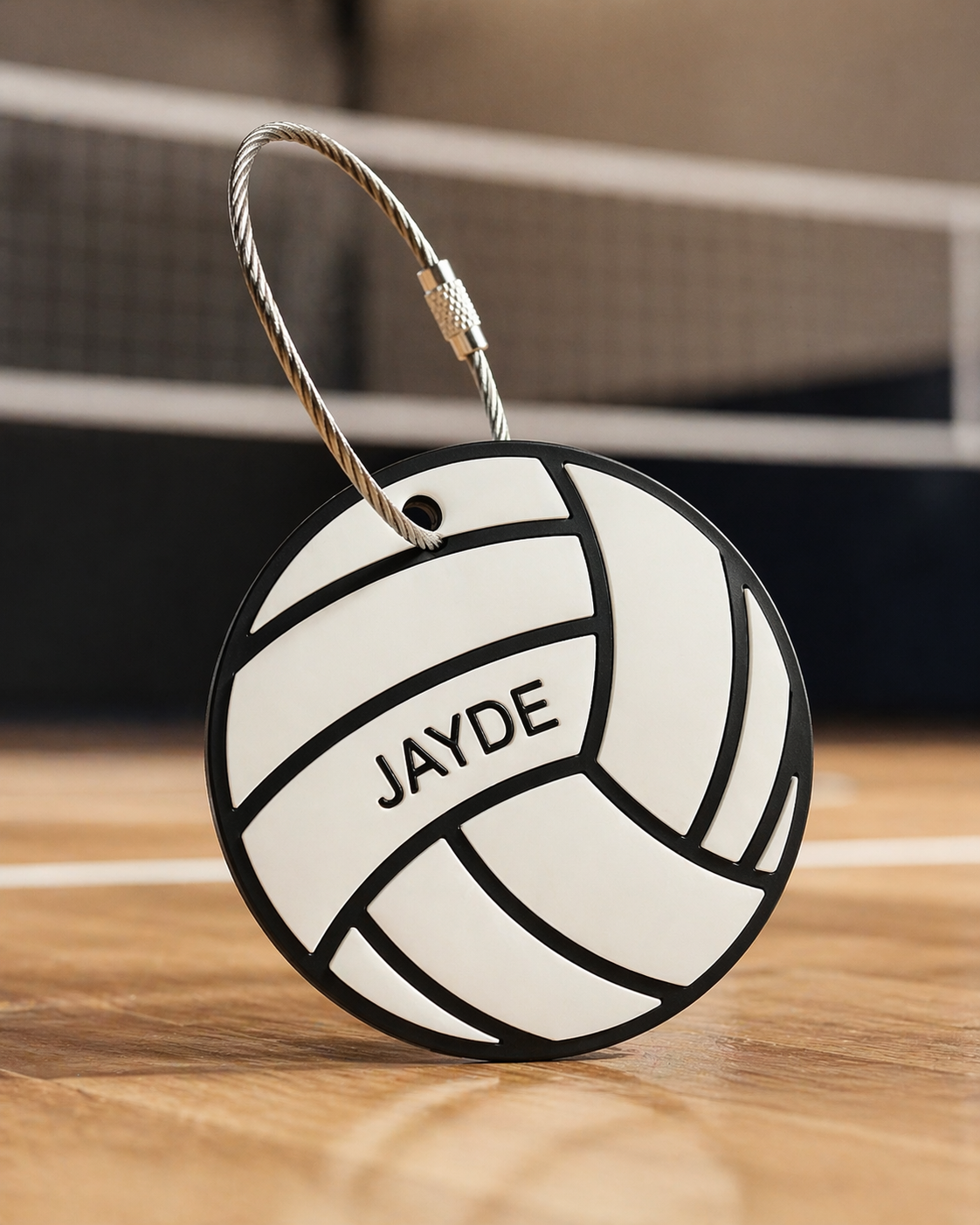 Volleyball bag tag with wire loop displayed on a gym floor