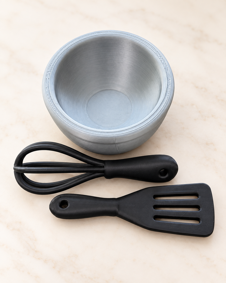 3D printed pretend whisk and spatula beside a mixing bowl